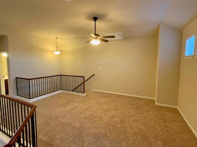 Carpeted empty room featuring vaulted ceiling, a 