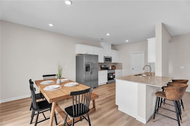 Kitchen featuring a sink, light wood-type flooring