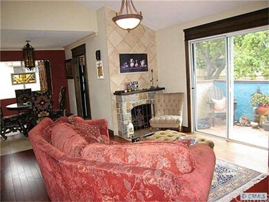 View of living room with vaulted ceiling, fireplac