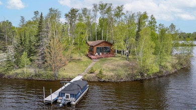 Dock featuring a water view and a lawn