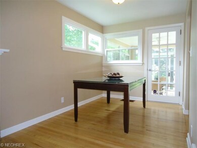 The dining room features hardwood floors and a doo