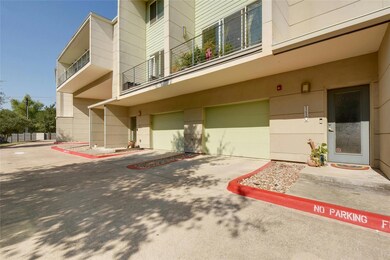 View of building exterior with a garage and concr