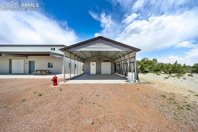 View of front of home featuring a garage and an ou