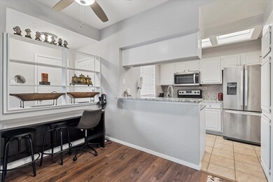 Kitchen featuring kitchen peninsula, appliances wi