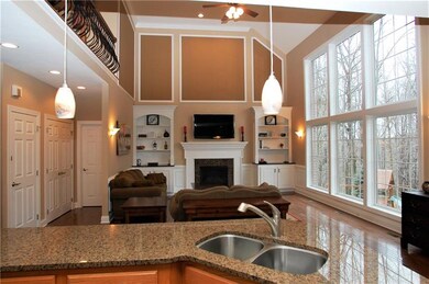 The two story family room is adorned with a wall o
