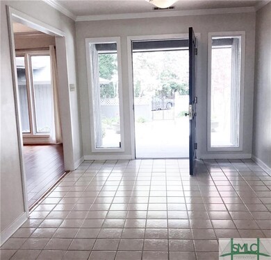 Wide foyer accommodates furniture, art work AND gu