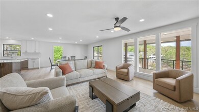 Main level living room with large windows providing a lot of natural light.