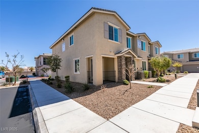 View of front of home with stucco siding, central air condition unit, and a residential view