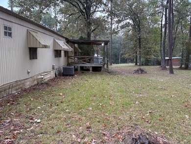 View of green lawn featuring a wooden deck