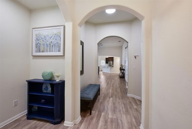 Hall featuring wood finished floors, baseboards, 