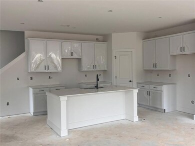 Spacious kitchen white cabinets and black fixtures.  Home will include a side by side stainless steel refrigerator.
