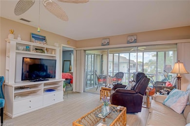 Living room with light wood finished floors and a ceiling fan