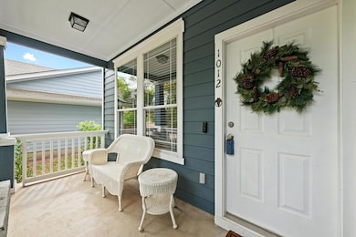Doorway to property with covered porch