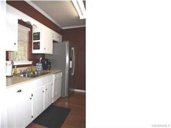 This galley kitchen has smooth surface counter top