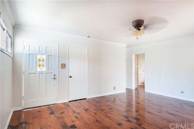 Enter to a bright Living Room with gleaming wood f