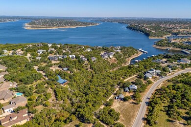 Aerial view of property's location featuring a large body of water and nearby suburban area