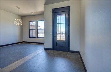 Entryway featuring an inviting chandelier and dark