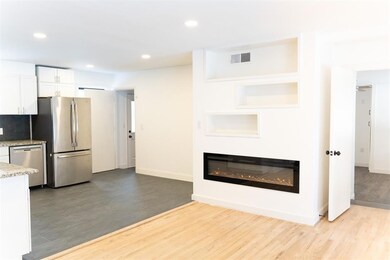 enter your home to this sleek, modern fireplace th