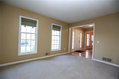 Formal living room has pocket door to family room