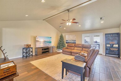 Living room featuring lofted ceiling, dark wood-ty