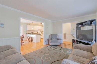Formal living room is currently being used as a family room.  Notice the hardwood floors, wainscoting, and crown molding.