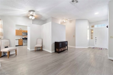 Living area with ceiling fan, lofted ceiling, ligh