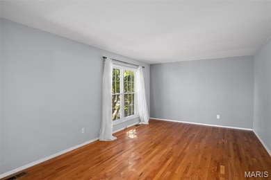 Spare room featuring light wood-type flooring and baseboards