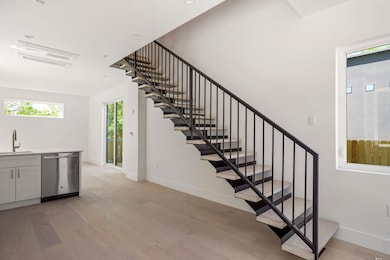 Stairs with wood finished floors and baseboards