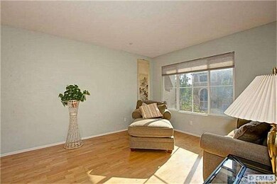 Lustrous light maple floors and soft sage green wa