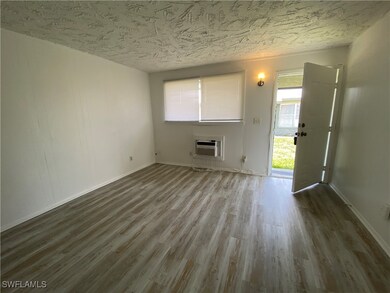 Unfurnished living room with wood finished floors,