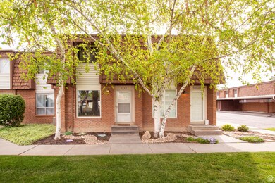View of front of property with a front lawn, entry steps, and brick siding