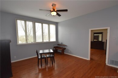 Living room features hardwood floor, ceiling fan a
