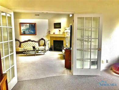 View from sun room into living room. Berber carpet