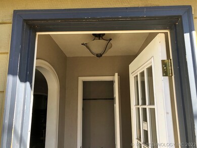 Entrance way has a coat closet and arched opening