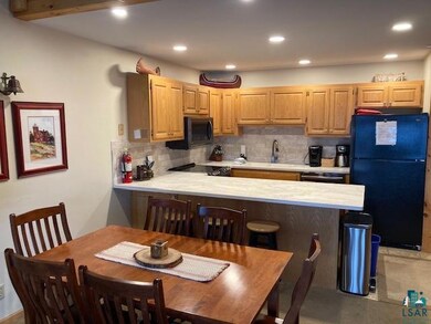 Kitchen featuring light brown cabinetry, decorativ