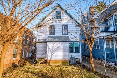 Rear view of property with cooling unit