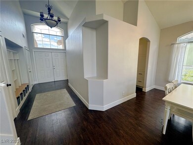 Entryway featuring dark wood-type flooring, arched