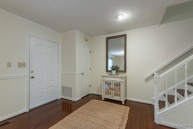 Coat closet opposite handsome staircase to second