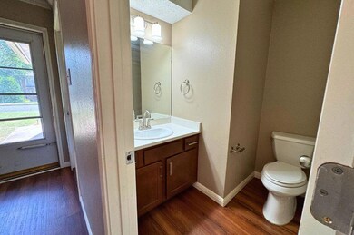 Bathroom with vanity, wood finished floors, and h