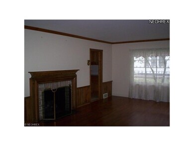 The large living room boasts gorgeous hardwood flo