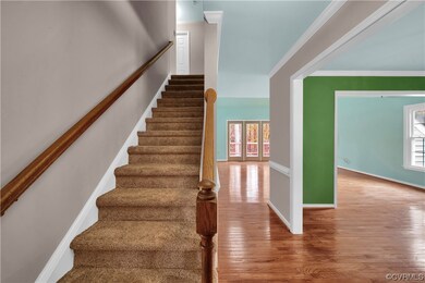 Stairs with crown molding and light hardwood / woo