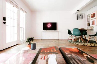 Living room with wood finished floors and baseboa