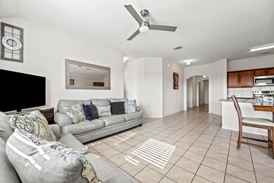 Open living room with a ceiling fan and lots of na