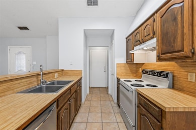 Kitchen featuring backsplash, white range with ele