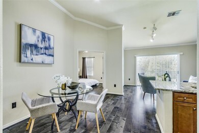 Dining room featuring crown molding and dark wood-