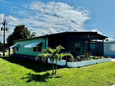 View of side of property featuring a yard