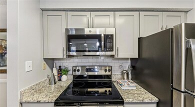 Kitchen with light stone countertops, stainless st