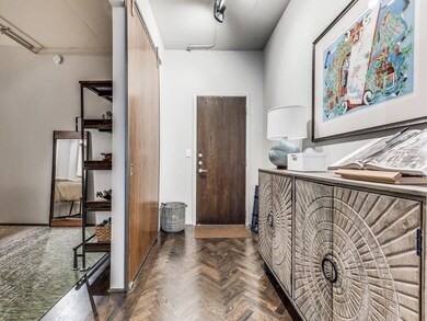 View of front door and entry to downstairs bedroom