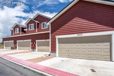 View of front of property featuring a garage and central air condition unit