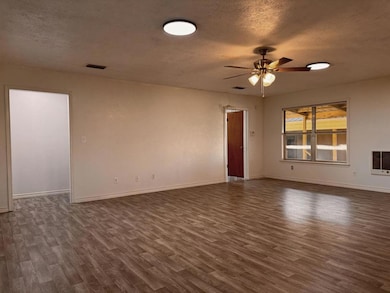 Unfurnished room featuring dark wood-style floori